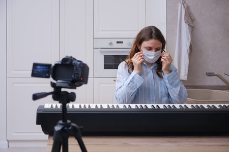 Online piano lessons and video recording of playing a musical instrument in isolation during the quarantineの写真素材