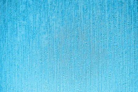 Texture with streaks of light blue paint on a rough surface, background