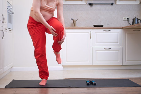 Yoga at home during pregnancy and problems with getting a knee injury. Pregnant woman on Vorkuta...