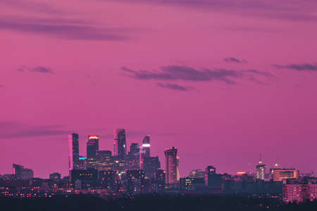 Pink sky over city buildings with towers of skyscrapers Moscow cityの写真素材