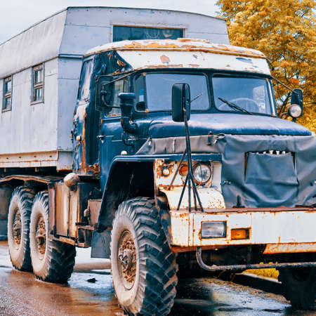 Old truck patched with tarpaulin with a living compartment in the backの写真素材