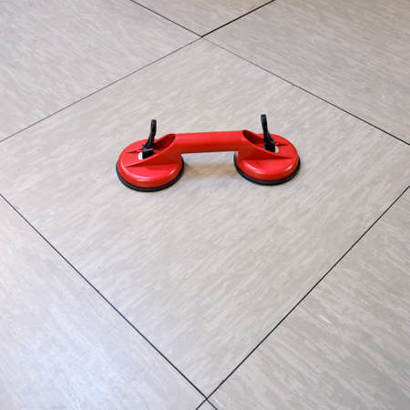Vacuum equipment in red for removing tiles from floors, close upの写真素材