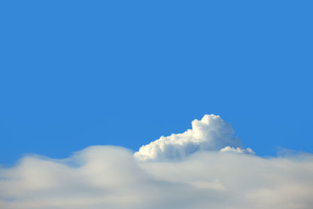 Background of bright blue cloudy sky, sunny day