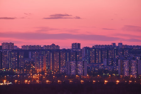 City houses against the background of a red sunset sky, copy space