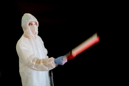 Disinfectant in a protective suit against coronavirus with decontamination equipment, copy space for textの写真素材
