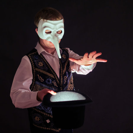 Magician wearing a plague doctor mask on his face, black backgroundの写真素材