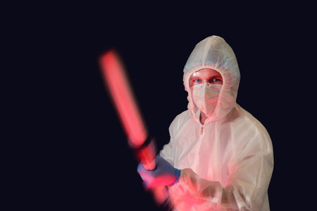 Disinfectant in covid protective suit with disinfection equipment, black background