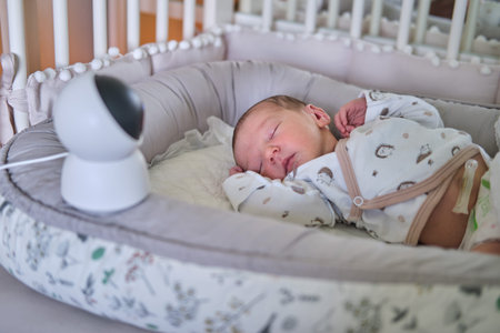 A home surveillance camera looks at the crib with a sleeping newborn baby