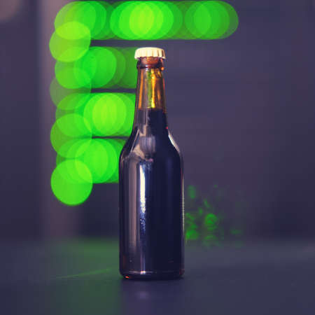 High tech and a bottle of alcohol on a bokeh background from lamps of server equipmentの写真素材
