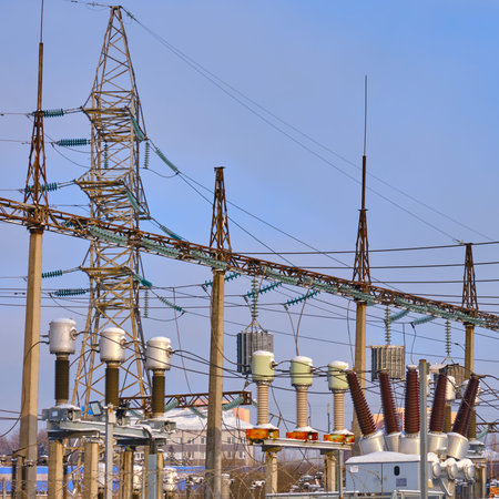 Power plant in winter with electricity transformers covered with snow