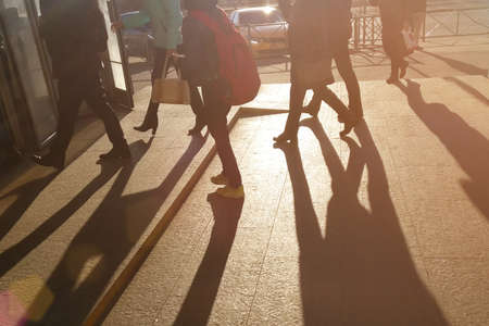 Summer in the hurrying city. The photo shows the feet of people walking. Everyone is busy with their urgent businessの写真素材
