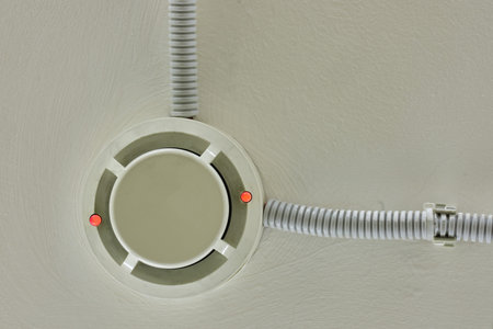 Flashing red lights fire alarm system on the ceiling in the room building. Smoke detector fire alarm sensorの写真素材
