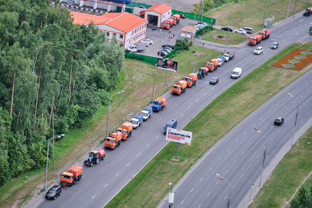 Road equipment for washing streets stands in a column on the road with cars and trucks - Moscow, Russia, July 15, 2021のeditorial素材