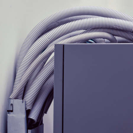 Electric cables and wires in white plastic corrugation, close upの写真素材