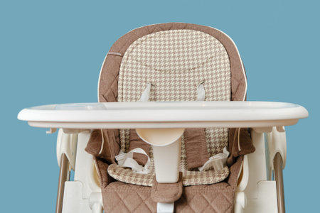High chair for feeding children, blue studio background