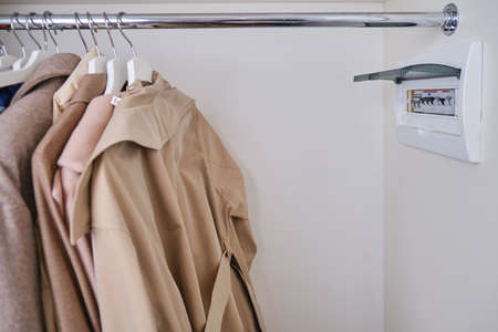 Automatic fusein a home electrical panel in the closet with clothes. Electricity equipment in the apartment, living room in the wardrobeの写真素材