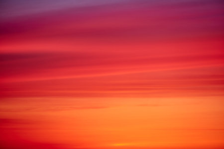 Evening red clouds in the sunset sky. Nature in colors from blue-purple to yellow-pink after sundownの写真素材