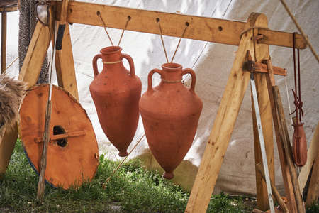 Ancient Roman camp items - jug, swords and shield. Reconstruction of military events during the wars of the Roman Empireの写真素材