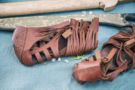 Ancient Roman training weapons and leather sandal caligae. Reconstruction of military events during...