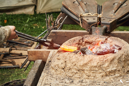 Work of a medieval blacksmith for the manufacture of metal products. Reconstruction of the events of...