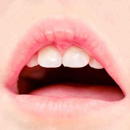 Upper teeth and baby tongue age one year close-up, child mouth macro photoの写真素材
