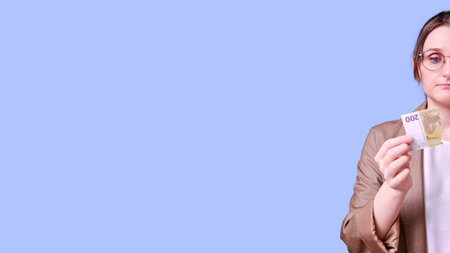 Sad woman teacher with torn euro banknote money on blue background, banner copy space