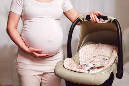 Baby car seat in pregnant woman, home living room