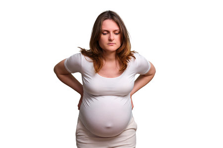 Back pain problems during pregnancy in women, studio white background