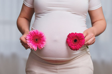 Two fetal pregnancy in a woman, home living roomの写真素材