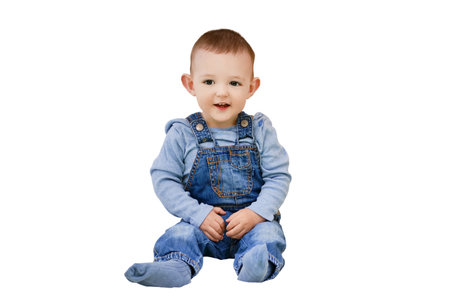 Happy toddler baby boy sitting in a children tent, playroom, isolated on a white background. Kid age one yearの写真素材