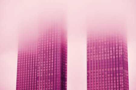 Windows of skyscrapers in the fog, background copy space. Metal structures with windows of a...
