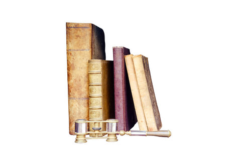 Old books and binoculars on a vintage shelf in the closet, isolated on a white backgroundの写真素材