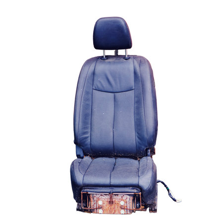 An old leather boss chair with ragged upholstery, bankruptcy concept and business problems, isolated on a white background. Red brick wall with place for text, copy spaceの写真素材