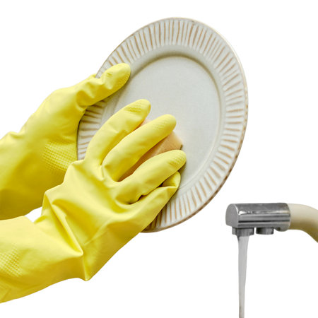 A woman washes a plate with a sponge in the sink while cleaning the home kitchen, isolated on a white backgroundの写真素材