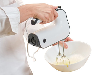 An adult woman in white chef's clothes cooks food in a home kitchen, isolated on a white backgroundの写真素材