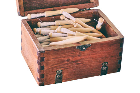Vintage box of spools for yarn, isolated on a white background. Coil retro with coiled spindle for...