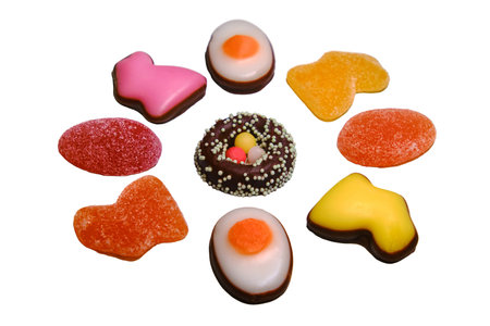 Easter candy in the form of a rabbit made of marmalade and chocolate eggs on a white backgroundの写真素材