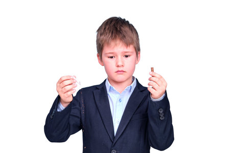 A boy in a school suit with a broken cigarette, isolated on a white backgroundの写真素材