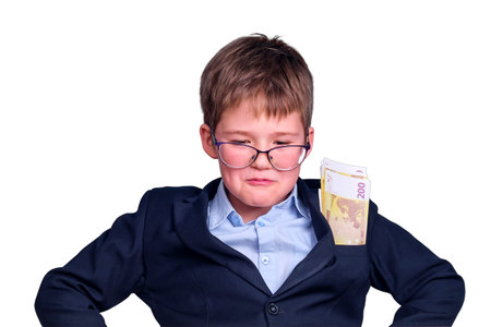 Boy student at school desk with euro money in his pocket, isolated on a white backgroundの写真素材
