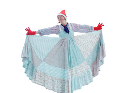 Happy woman dancing in blue dress and santa hat on christmas, isolated on white backgroundの写真素材