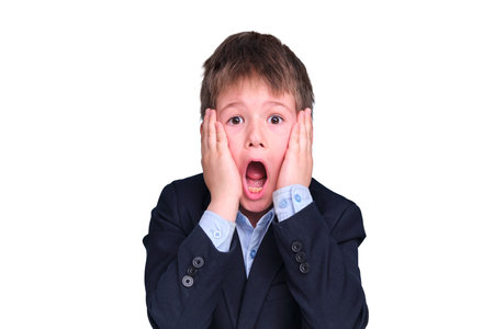 A scared boy in a school suit on distance learning, isolated on a white backgroundの写真素材
