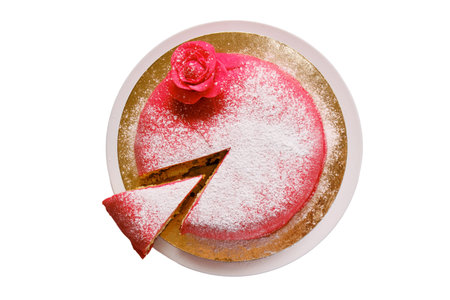 Red cake covered with marzipan or mastic with a cut piece, copy space, isolated on a white backgroundの写真素材