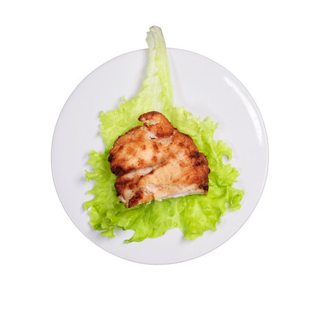 Meat cutlet with stuffing on a lettuce leaf, isolated on a white background. Plate with cutlet in Kiev, Ukraineの写真素材