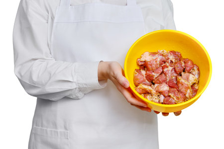 Chef with marinated meat for barbecue in hands on isolated on a white background, copy spaceの写真素材