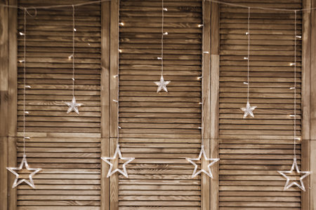 Background of wooden slats with lamps in the form of starsの写真素材