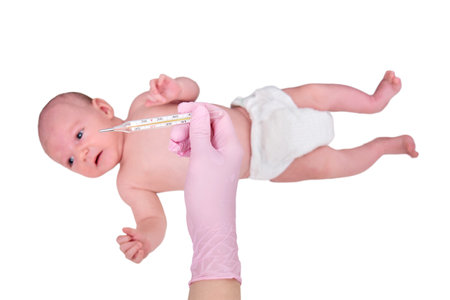Doctor checks the temperature of the newborn baby with a thermometer, isolated on a white background. A nurse in uniform measures the child fever with a thermometer. Kid aged two monthsの写真素材