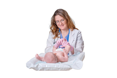 The doctor does gymnastics and massage to a newborn baby, isolated on a white background. Nurse in uniform doing warm-up exercises to the child. Kid aged two monthsの写真素材