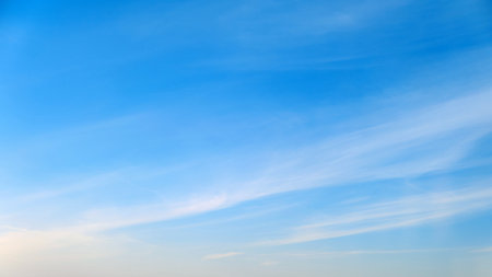 White cirrus and stratus clouds in a blue daytime skyの写真素材
