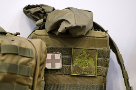 Bags Rosgvardiya for medical items and red cross. Army pouches and a holster with weapons for military uniforms - Moscow, Russia, April 21, 2023のeditorial素材