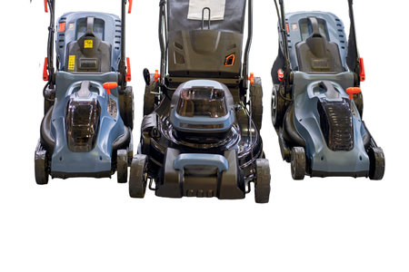 Lawn mowers in the store, sale of garden equipment in the market, isolated on white backgroundの写真素材